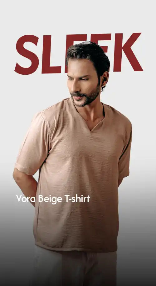 A man modeling a beige, short-sleeved V-neck t-shirt.