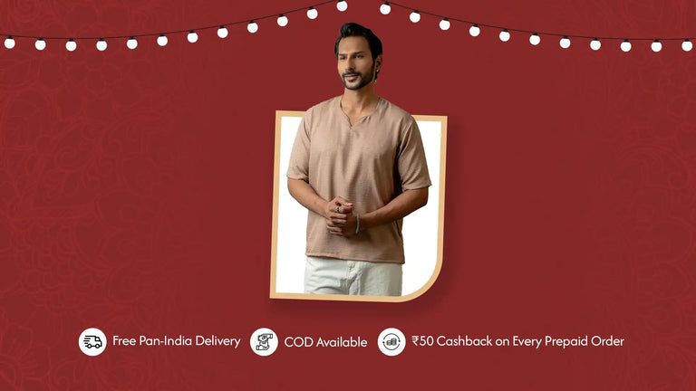 Man modeling a light brown, short-sleeved top with a V-neck and white pants.