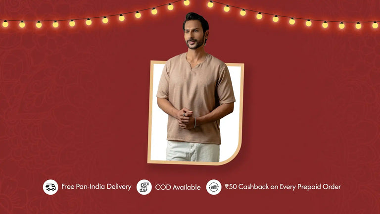 A man modeling a light brown v-neck short-sleeved tunic and white pants.