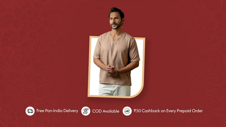 A man modeling a light brown v-neck short-sleeved top and white pants.