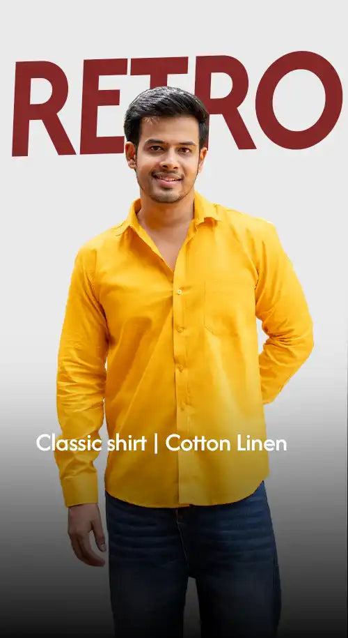 A man wearing a yellow long-sleeved collared shirt and blue jeans.